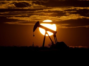 The sun sets behind an idle pump jack near Karnes City, Texas, April 8, 2020.