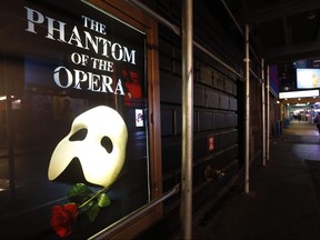 A poster advertising "The Phantom of the Opera" is shown on the shuttered Majestic Theatre on a nearly deserted side street near Times Square on March 12, 2020, in New York.