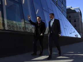 Pierre Poilievre walks with Andrew Scheer as they arrive for a press conference outside the Bank of Canada in Ottawa, April 28, 2022.