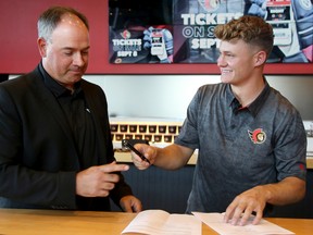 Tim Stutzle is seen with GM Pierre Dorion on Wednesday, when he signed the biggest contract in Ottawa Senators history.