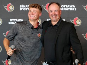 Tim Stutzle and GM Pierre Dorion are seen together at the Canadian Tire Centre after Stutzle signed Wednesday.