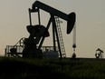 Pumpjacks spin on a field west of Sexsmith, Alta., June 9, 2015.