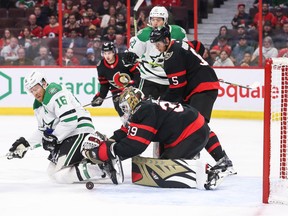 OTTAWA, CANADA - OCTOBER 24: Magnus Hellberg #39 of the Ottawa Senators moves to cover the puck as Joe Pavelski #16 of the Dallas Stars looks on in the first period at Canadian Tire Centre on October 24, 2022 in Ottawa, Ontario, Canada.