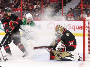 Magnus Hellberg of the Ottawa Senators makes a save as Radek Faksa of the Dallas Stars sprays ice at Hellberg as Mark Kastelic looks on in the first period at Canadian Tire Centre on Oct. 24, 2022.
