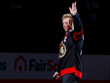 Ottawa Senators legend Daniel Alfredsson acknowledges the crowd as he takes the ice to drop the puck for a ceremonial faceoff for the Sens' home opener on Oct. 18, 2022.