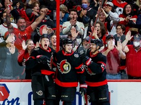 Ottawa Senators left wing Brady Tkachuk (7) celebrates a goal with teammates Drake Batherson (19) and Travis Hamonic during first period NHL action at Canadian Tire Centre on Oct. 18, 2022.