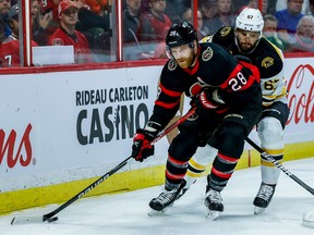 Ottawa Senators right wing Claude Giroux (28) keeps the puck away fom Boston Bruins defenceman Jakub Zboril (67) during first period NHL action at Canadian Tire Centre on Oct. 18, 2022.