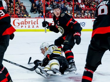 Ottawa Senators left wing Brady Tkachuk (7) dumps Boston Bruins centre Charlie Coyle (13) during first period NHL action at Canadian Tire Centre on Oct. 18, 2022.