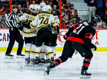 Boston Bruins celebrate a goal as Ottawa Senators right wing Mathieu Joseph (21) skates back to the bench during second period NHL action at Canadian Tire Centre on Oct. 18, 2022.