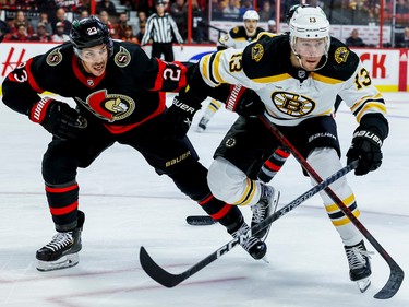 Ottawa Senators defenceman Travis Hamonic (23) battles with Boston Bruins centre Charlie Coyle (13) during second period NHL action at Canadian Tire Centre on October 18,2022.