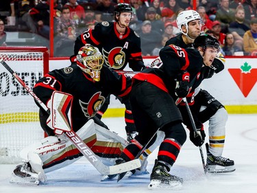 Ottawa Senators goaltender Anton Forsberg (31) looks for the puck as  defenceman Jake Sanderson (85) checks centre Patrice Bergeron (37) during second period NHL action at Canadian Tire Centre on Oct. 18, 2022.