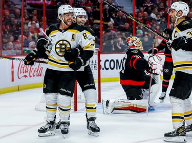 Boston Bruins right wing David Pastrnak (88) celebrates a goal on  Ottawa Senators goaltender Anton Forsberg (31) with teammates during second period NHL action at Canadian Tire Centre on Oct. 18, 2022.