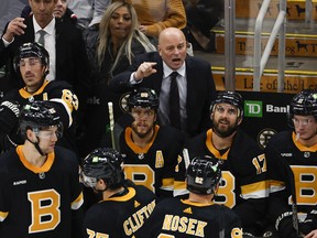 Boston Bruins head coach Jim Montgomery talks with his players during the third period against the Detroit Red Wings at TD Garden.
