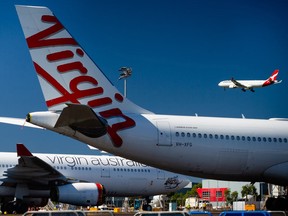 Virgin Australia aircraft are seen parked on the tarmac at Brisbane International airport on April 21, 2020.