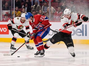 Montreal Canadiens forward Cole Caufield (22) takes the puck away from Ottawa Senators forward Shane Pinto (57) during the third period at the Bell Centre.