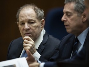 Former film producer Harvey Weinstein (left) interacts with his attorney Mark Werksman in court at the Clara Shortridge Foltz Criminal Justice Center in Los Angeles, Oct. 4, 2022.