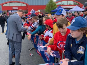 Senators defenceman Nick Holden signs autographs for fans — even those of the rival Montreal Canadiens — as he enters the Steele Community Centre Arena in Gander, N.L., on Thursday.