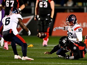 Alouettes defensive lineman Thomas Costigan forces a fumble off Redblacks quarterback Nick Arbuckle (19), leading to a touchdown by Alouettes defensive back Adarius Pickett (6) in the first quarter.
