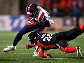 Montreal Alouettes wide receiver Eugene Lewis (87) tries to evade the tackle of Ottawa Redblacks defensive back Damon Webb (34) during first half CFL football action in Ottawa on Friday, Oct. 14, 2022.