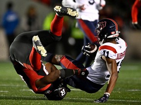 Redblacks linebacker Avery Williams rolls upside down as he tackles Alouettes wide receiver Kaion Julien-Grant during the first half of Friday's game.