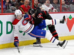 Ottawa Senators right wing Alex DeBrincat (12) battles with Montreal Canadiens defenceman Brendan Guhle (21) during second period NHL pre-season hockey action in Ottawa, on Saturday, Oct. 1, 2022.