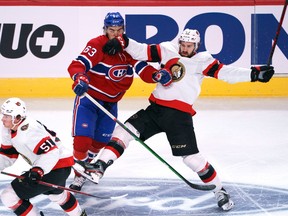 Centre Mark Kastelic, right, bidding for a fourth-line spot on the Senators' roster, collides with the Canadiens' Arber Xhekaj during a pre-season game at Montreal on Oct. 2.