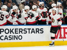 Ottawa Senators centre Shane Pinto (57) celebrates at the bench after scoring a goal against the Toronto Maple Leafs during the first period at Scotiabank Arena.