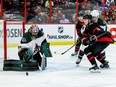 Ottawa Senators centre Josh Norris and Coyotes goaltender Karel Vejmelka track a rebound during the third period of Saturday's game. Norris later suffered what appeared to be a shoulder injury.