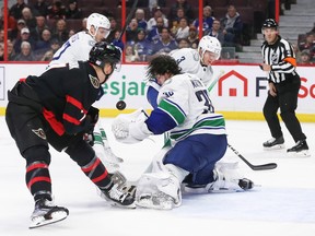 Vancouver Canucks goalie Spencer Martin's mask is knocked off by Brady Tkachuk's shot during the second period of the game at Canadian Tire Centre on Tuesday night.