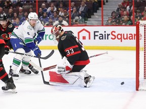 OTTAWA, CANADA - NOVEMBER 08: Oliver Ekman-Larsson #23 (not shown) scores against Cam Talbot #33 of the Ottawa Senators as Brock Boeser #6 looks on in the third period of the game at Canadian Tire Centre on November 08, 2022 in Ottawa