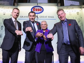 Former Senators captain Daniel Alfredsson, far right, joins, from left, Daniel Sedin, Roberto Luongo and Bernice Carnegie (accepting for her deceased father Herb Carnegie) show off their Hockey Hall of Fame induction rings on Friday.