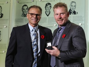 The chairman of the selection committee, Mike Gartner, presents a Hockey Hall of Fame ring to Daniel Alfredsson in Toronto on Friday. The official induction ceremony will be Monday evening.