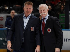 Daniel Alfredsson receives his Hockey Hall of Fame jacket from Lanny McDonald.