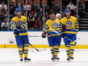 Left to right: Daniel Sedin, Daniel Alfredsson and Henrik Sedin skate in the Hockey Hall of Fame Legends Classic game at the Scotiabank Arena in Toronto, Nov. 13, 2022. The Hall induction ceremony will take place on Monday, Nov. 14.