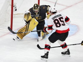Logan Thompson (36) of the Vegas Golden Knights blocks a shot from Jake Sanderson (85) of the Ottawa Senators in the second half of their game at T-Mobile Arena on November 23, 2022 in Las Vegas, Nevada.  The Golden Knights defeated the Senators 4-1.
