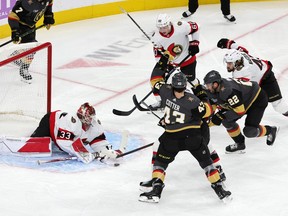 Cam Talbot #33 of the Ottawa Senators makes a save against Michael Amadio #22 of the Vegas Golden Knights in the third period of their game at T-Mobile Arena on November 23, 2022 in Las Vegas, Nevada.