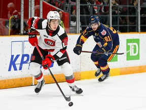 Matthew Mayich of the OTtawa 67s looks for a teammate to pass to as xxxxx of the Barrie Colts closes in on him in last nights game at TD Place.