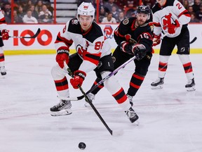 Ottawa Senators left wing Austin Watson (16) checks New Jersey Devils centre Jack Hughes (86) during third period NHL action at the Canadian Tire Centre on Saturday, Nov. 19, 2022.