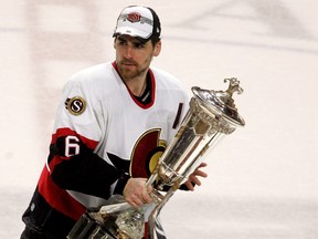 Wade Redden picks up the Prince of Wales trophy  after his team's 3-2 victory over the Buffalo Sabres in Game 5 of the 2007 Eastern Conference Finals on May 19, 2007 at the HSBC Center in Buffalo, New York.