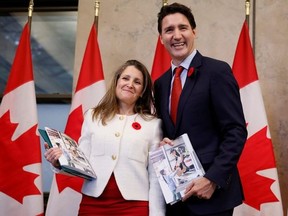 Deputy Prime Minister and Minister of Finance Chrystia Freeland and Prime Minister Justin Trudeau stop for a photo before delivering the fall economic statement on Parliament Hill in Ottawa, Thursday, Nov. 3, 2022.