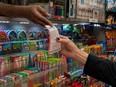 A person receives a lottery ticket for Powerball's $1.6 billion dollar jackpot in New York City, Friday, Nov. 4, 2022.