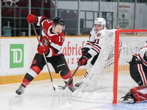 Brady Stonehouse (17) of the 67's eludes Daniel Michaud (91) of the IceDogs before scoring a "lacrosse" goal against netminder Josh Rosenzweig of Saturday's Ontario Hockey League game.