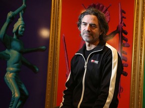 Greg A. Hill, who was curator of Indigenous art for the National Gallery of Canada, was one of four senior gallery staff fired on Friday as part of a 'restructuring'. Hill was photographed Monday in front of some of his own art at his Chelsea home.