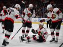 Senators teammates Derick Brassard (61), Shane Pinto (57) and Claude Giroux (28) celebrate on goal by Mathieu Joseph (21) during the third period of Friday's game against the Ducks.
