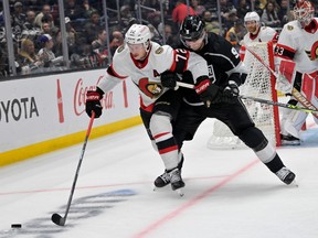 Ottawa Senators defenceman Thomas Chabot (72) and Los Angeles Kings right wing Adrian Kempe (9) battle for the puck in overtime at Crypto.com Arena during a game Nov. 27, 2022.