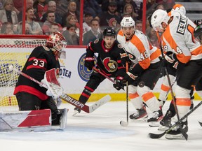 Nov 5, 2022; Ottawa, Ontario, CAN; Philadelphia Flyers center Morgan Frost (48) and left wing Nicolas Deslauriers (44) follow the puck as it soars in the air in front of Ottawa Senators goalie Cam Talbot (33) in the second period at the Canadian Tire Centre.