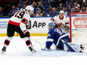 The Ottawa Senators' Tim Stutzle (18) passes the puck to Drake Batherson, who is stopped by Tampa Bay Lightning goaltender Andrei Vasilevskiy in the second period at Amalie Arena on Tuesday night.