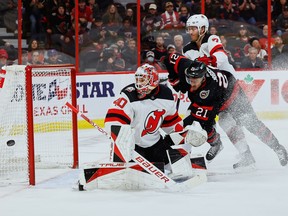 Senators winger Matthew Joseph tackles Devils defenseman Dougie Hamilton after a save by goaltender Akira Schmidt during the first period of Saturday's game at the Canadian Tire Center.