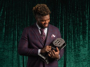 Lorenzo Mauldin, wearing a new Marc Enzo suit, accepted the CFL's Most Outstanding Defensive Player award Thursday night in Regina.