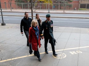 Maj.-Gen. Dany Fortin, right, arrives with his wife, Madeleine Collin, at a Gatineau courthouse on Tuesday, Oct. 25, 2022.